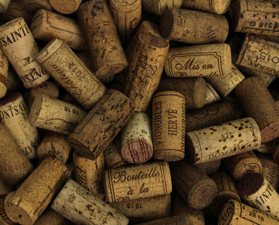 Wine corks from multiple wine vendors stacked on top of each other